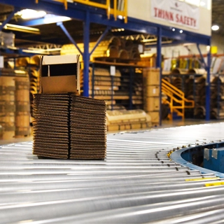 Corrugated Boxes on Conveyor Belt in Factory