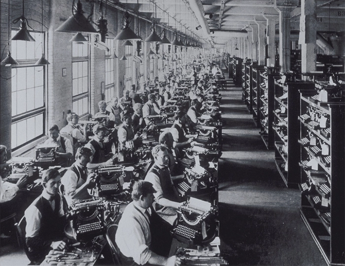 factory workers assemble typewriters in a typewriter factory