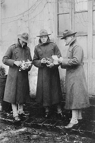WWI solders opening American Red Cross care packages in 1917